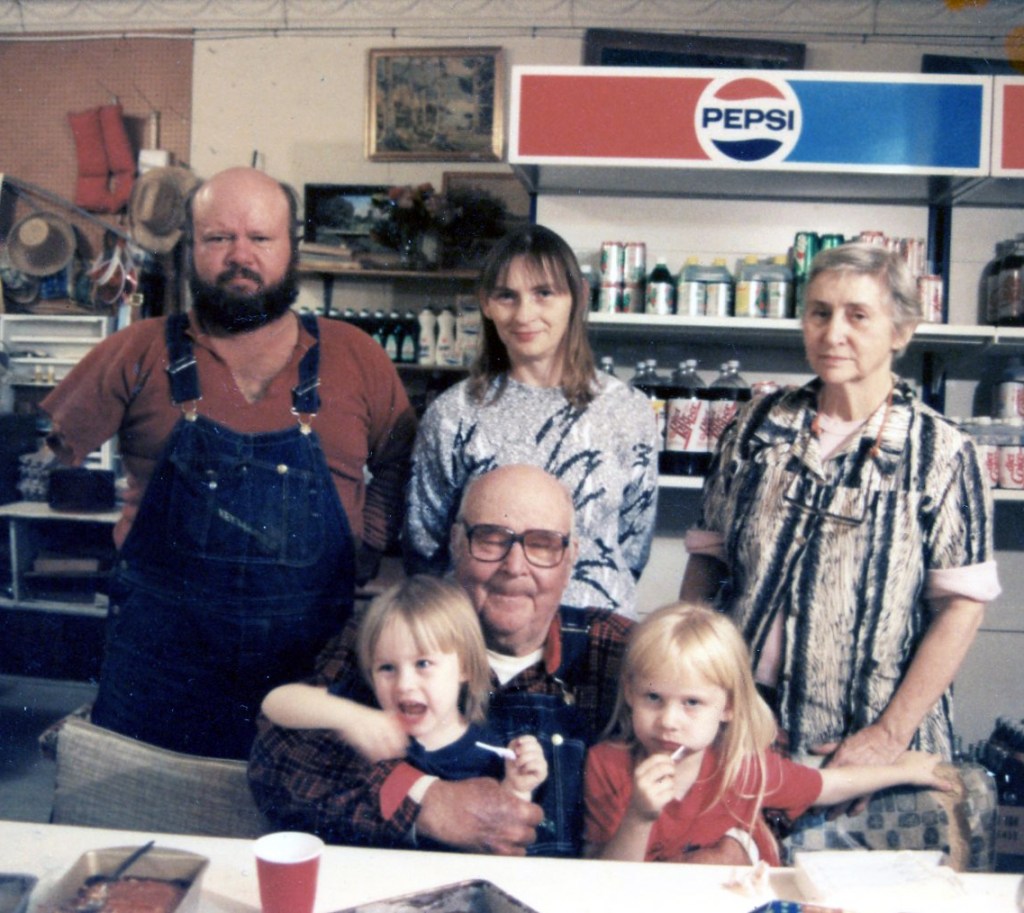 family standing in front of pepsi sign